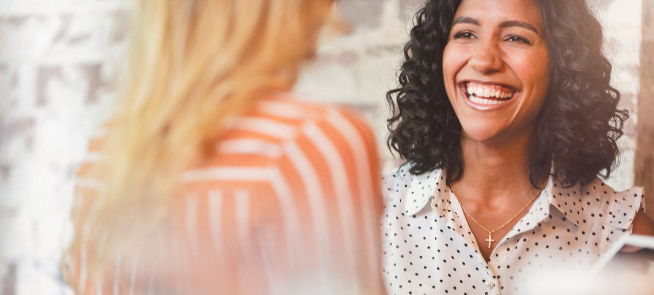 Two women colleagues meeting at office