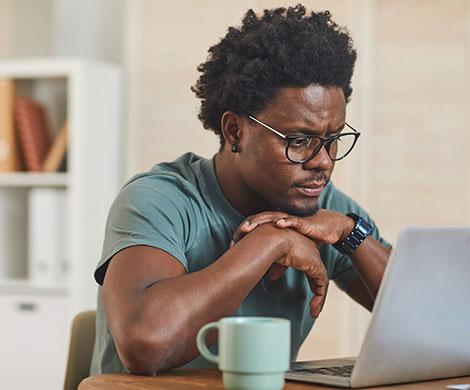 Man using laptop in living room