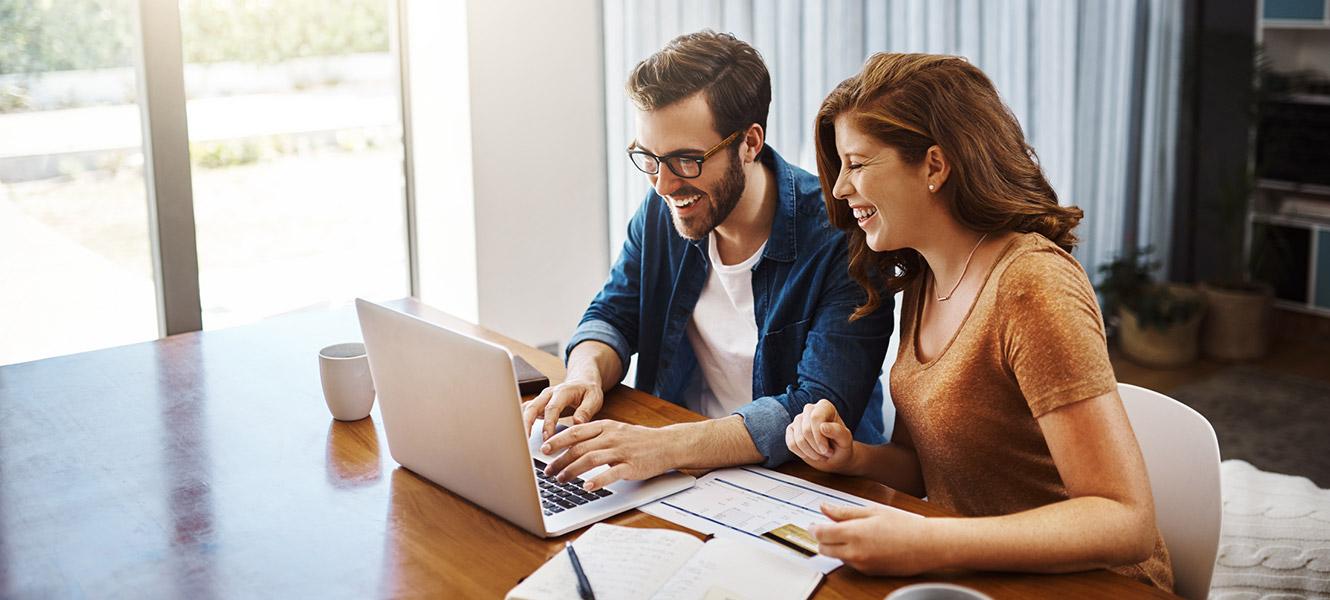 Young couple going over finances in kitchen