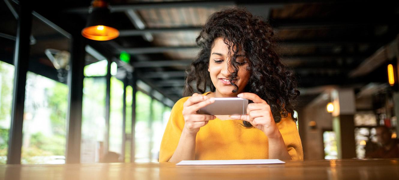 Woman scanning check with smartphone