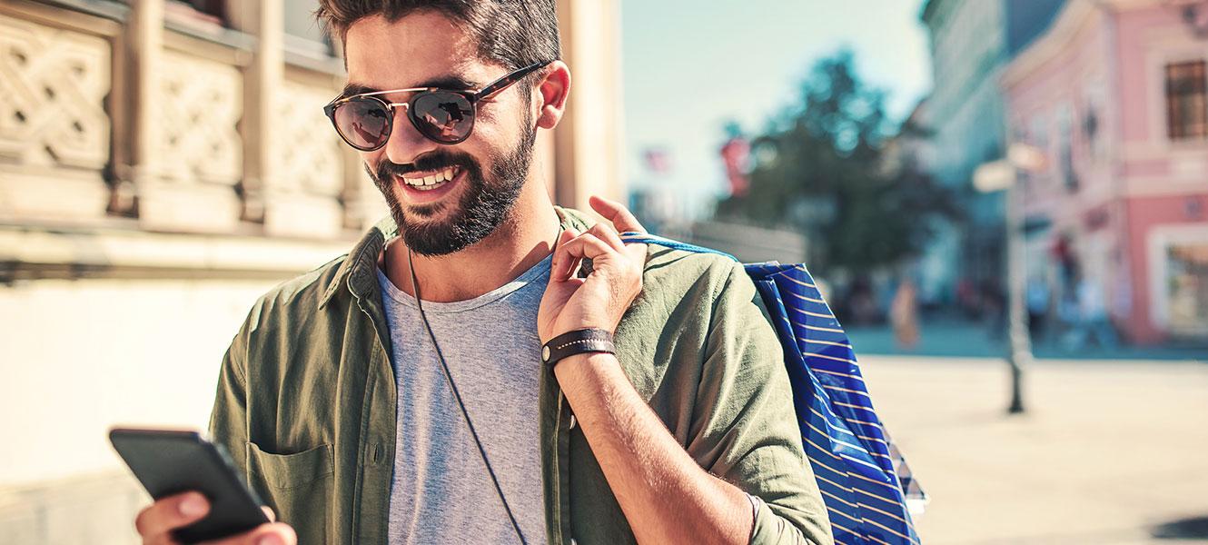 Young man using phone while in the city